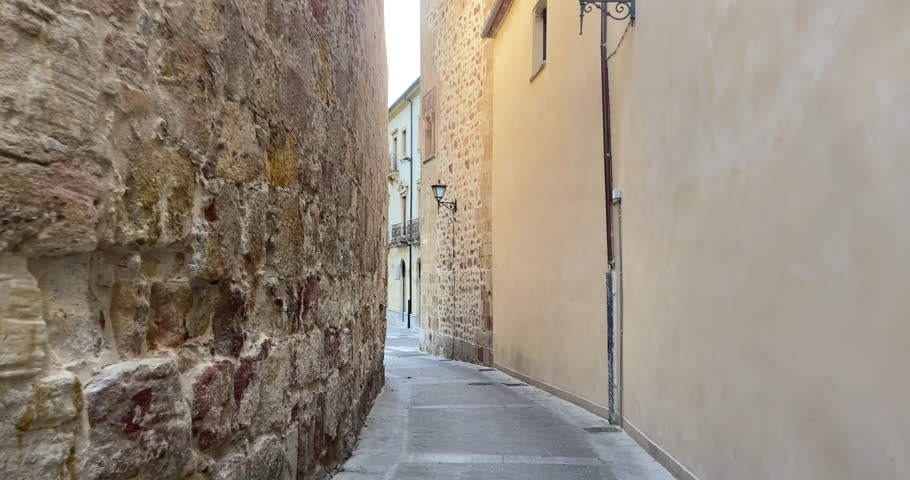 Beautiful shot walking down an alley in a traditional street in Salamanca, Spain during the day.