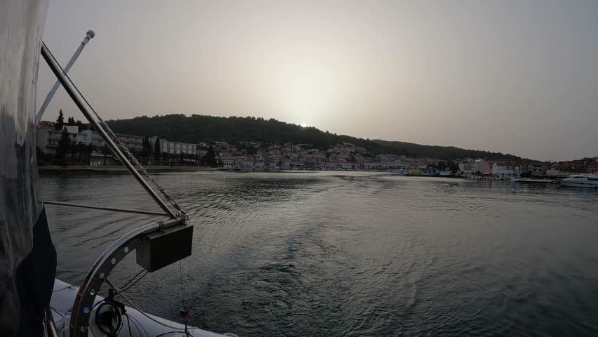 The ship leaving the port early in the morning
