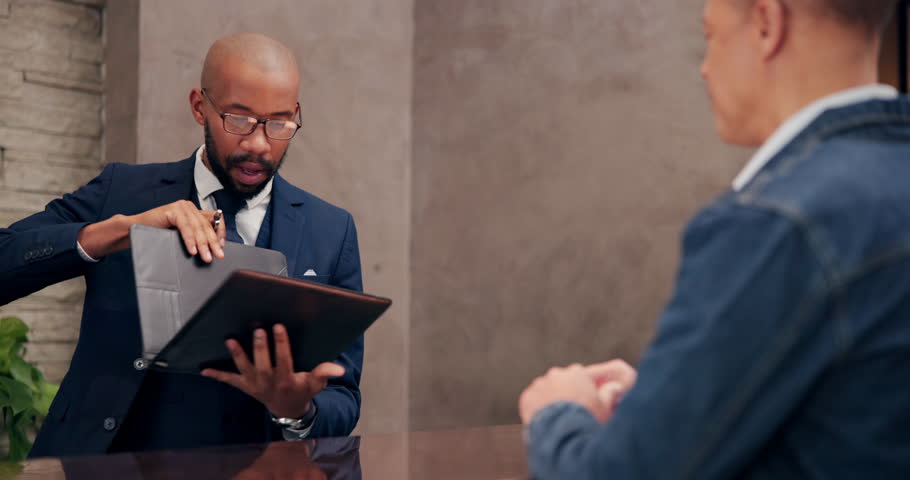 Hotel, employee and guest at reception for check in, hospitality and accommodation with documents. Signing, people and worker with luxury, industry and service with paperwork, concierge and tourism