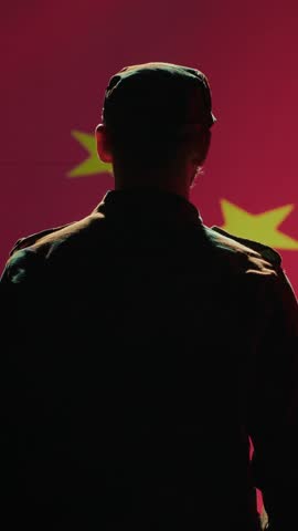 Vertical video Member of chinese army doing saluting hand gesture towards China flag in command center, showing respect. Military unit in uniform serving Chinese Communist Party, doing honoring