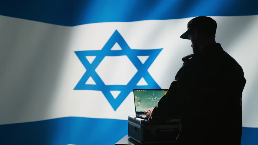 Iranian conscript in control room uses military tech to identify threats from enemies. Iran IDF army operator uses software on laptop to communicate information to generals on war front line, camera B