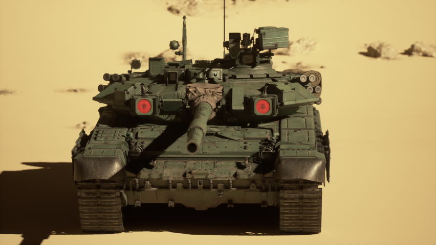A military tank advances through the desert sands, leaving tracks behind as it maneuvers the rugged terrain.