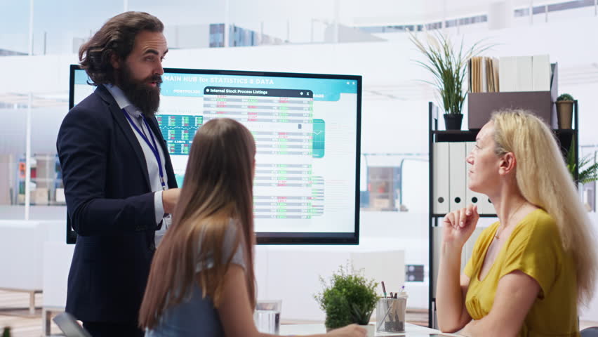 Financial advisor discussing with clients, recommending suitable financial products such as mutual funds. Agent teaching parent and daughter how to invest, offering statistical graphs, camera B - Powered by Shutterstock - Get 15% off with code: PIKWIZARD15