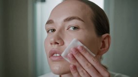 Beauty girl applying toner on ideal skin closeup. Attractive model cleansing face looking camera in home bathroom. Young pretty woman removing makeup. Luxury self-care treatment advertisement concept. - Powered by Shutterstock - Get 15% off with code: PIKWIZARD15