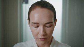 Portrait woman cleansing skin at home. Beautiful girl applying lotion on face looking camera in morning bathroom. Serene beauty model removing makeup touching with cotton pad. Daily beauty routine. - Powered by Shutterstock - Get 15% off with code: PIKWIZARD15