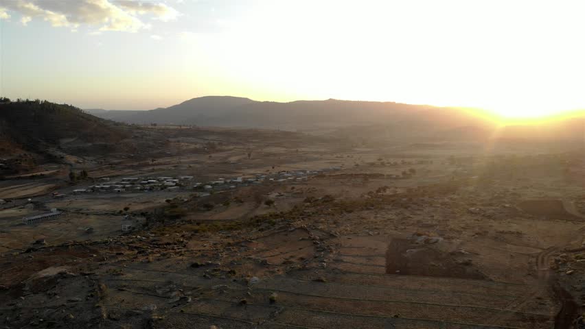 Aerial footage over Axum City area landscape with fields at sunset
Drone view over Axum City area landscape with fields and villages at sunset, Ethiopia

