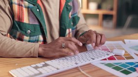 Color swatch, hands and keyboard with graphic designer at desk in office for feedback or planning. Administration, project management and typing with creative employee person at work on computer - Powered by Shutterstock - Get 15% off with code: PIKWIZARD15