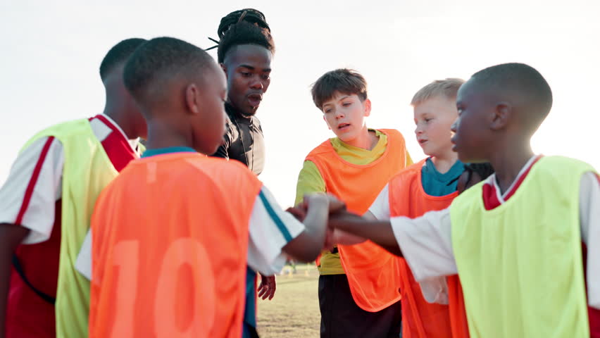 Football, hands and coach with children for celebrate, motivation and team spirit for sport competition. Soccer field, applause and trainer with players for win, achievement and confidence boost