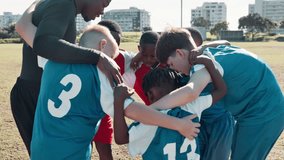 Coach, children and team with huddle for soccer, motivation or game plan with diversity on field. Man, football and group in scrum with support, connection and care with hug for solidarity on pitch - Powered by Shutterstock - Get 15% off with code: PIKWIZARD15