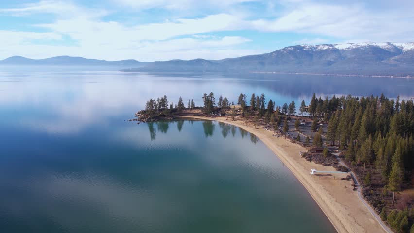 Aerial View of Lake Tahoe and Sand Harbor Park and Beach, Sky Reflections on Calm Water, Nevada USA, Drone Shot