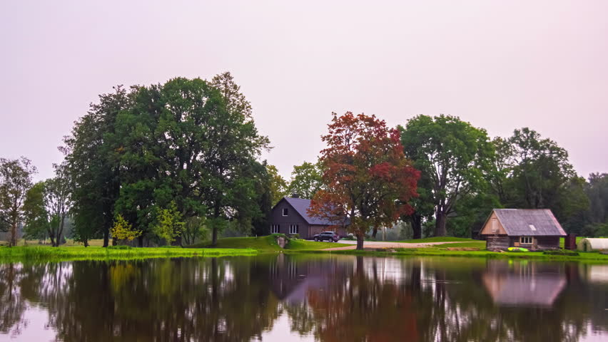 Long duration, all year, autumn through winter, spring, and summer time lapse of a cottage by a pond