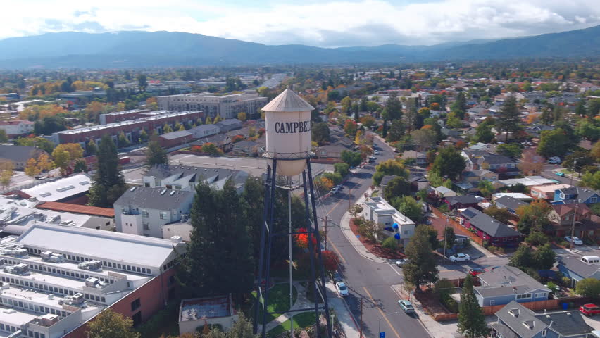 aerial view of a drone rotating around a watertower in cambell california 
