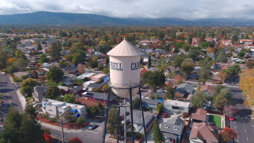 aerial view of a drone rotating around a watertower in cambell california 