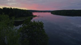 Sunset over a peaceful lake during the summer in Sweden. Shot with a drone. - Powered by Shutterstock - Get 15% off with code: PIKWIZARD15
