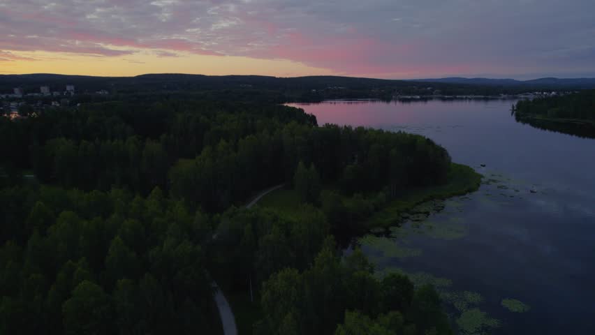 Sunset over a peaceful lake during the summer in Sweden. Shot with a drone.