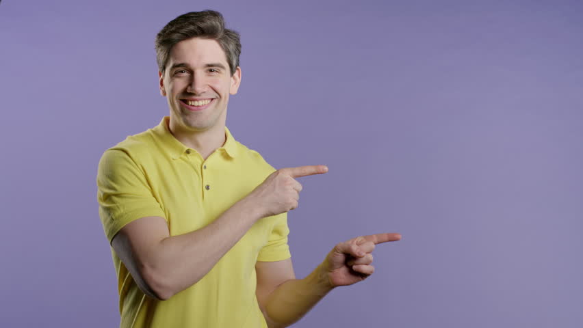 Happy smiling man presenting and showing something on violet,pointing copy space - Powered by Shutterstock - Get 15% off with code: PIKWIZARD15