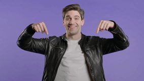 Blogger man pointing down advertising area. Violet background. Click, subscribe - Powered by Shutterstock - Get 15% off with code: PIKWIZARD15