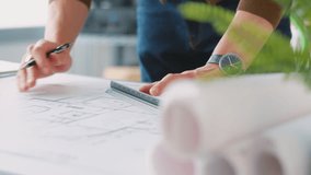 Close up of male architect in office drawing on plan or blueprint using ruler- shot in slow motion - Powered by Shutterstock - Get 15% off with code: PIKWIZARD15