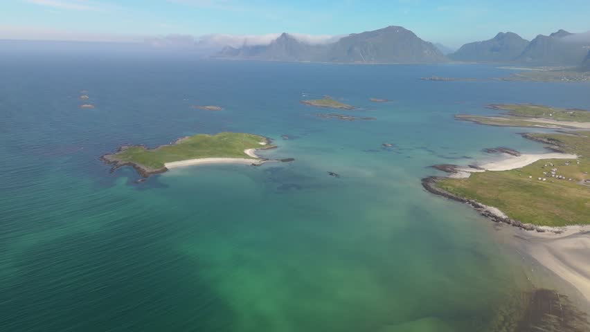 High-angle aerial view showcasing a stunning coastal landscape with turquoise waters and green islands. Lofoten Norway