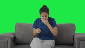 Sick Indian teenage girl having a cold and cough Green screen - Powered by Shutterstock - Get 15% off with code: PIKWIZARD15