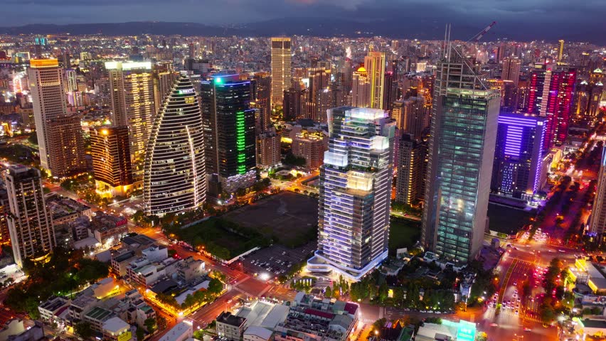 Aerial skyline of Downtown Taichung, a vibrant metropolis in central Taiwan, with modern high-rise office towers booming in the 7th Redevelopment Zone and city lights dazzling at night (in hyperlapse)