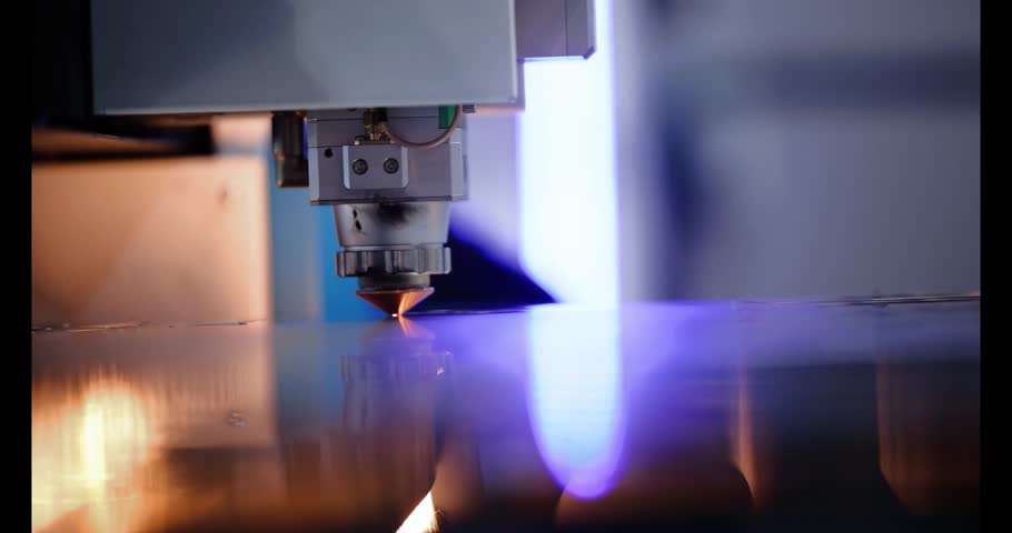 Laser CNC cut of metal with light spark. Blue color background banner, technology modern industrial.