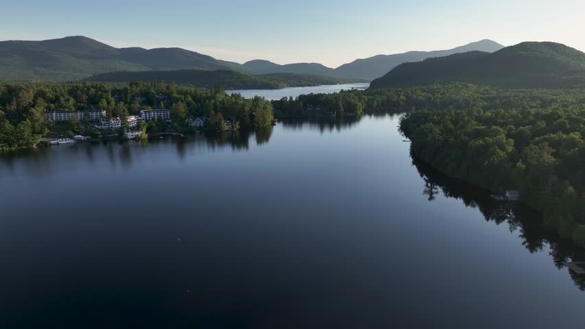 Approaching aerial view of Mirror Lake and Lake Placid in Lake Placid, New York