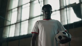 Future champion of soccer looking at camera, African American player with ball - Powered by Shutterstock - Get 15% off with code: PIKWIZARD15