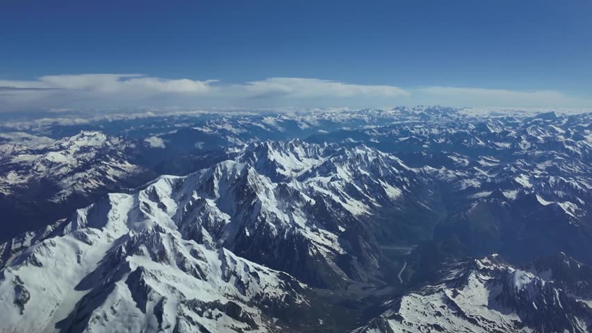 The Mont Blanc summit in The Alps Range. Elevated aerial view shot from a jet cockpit flying northbound at 1000m high. Switzerland.4K 60FPS