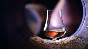 Bourbon whiskey trickles down the surface of a glass placed inside of old oak barrel brimming with barley grains. Capturing the essence of traditional alcohol production - Powered by Shutterstock - Get 15% off with code: PIKWIZARD15