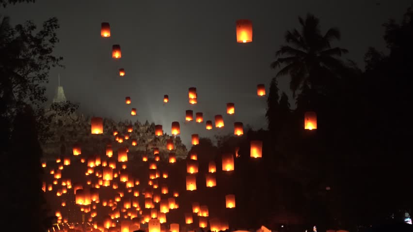 Indonesian people gathering together to release lantern during buddhism Vaisak Day celebration at Borobudur Temple.