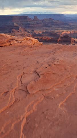 Dead Horse Point State Park, USA. Camera moving to the edge of cliff. View of Canyonlands National Park and Colorado River. Vertical shot