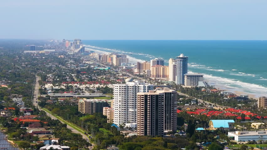 Expensive real estate on Atlantic ocean shore in Daytona Beach city in Florida, USA. Aerial view of wealthy waterfront neighborhood. Coastal housing development