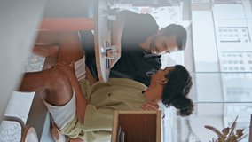 Sweet gay couple date in cafeteria. Two multiracial men talking together enjoying tender communication at cafe table vertical video. Happy relaxed homosexual guys have romantic meeting in coffee house - Powered by Shutterstock - Get 15% off with code: PIKWIZARD15