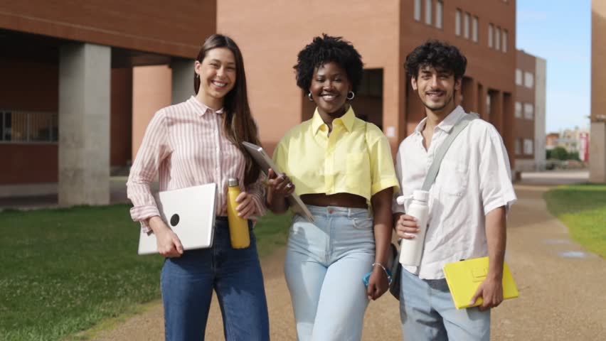 Portrait of three multiethnic students at college campus.