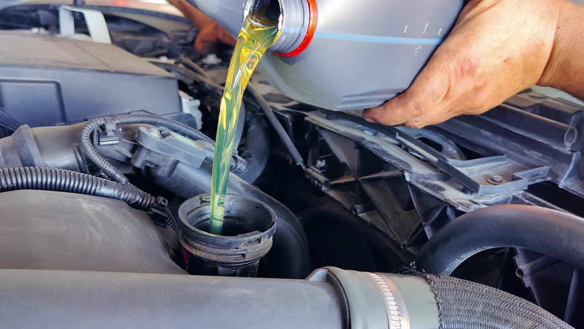 Pouring Synthetic Oil into the Engine at a Car Repair Service Footage.