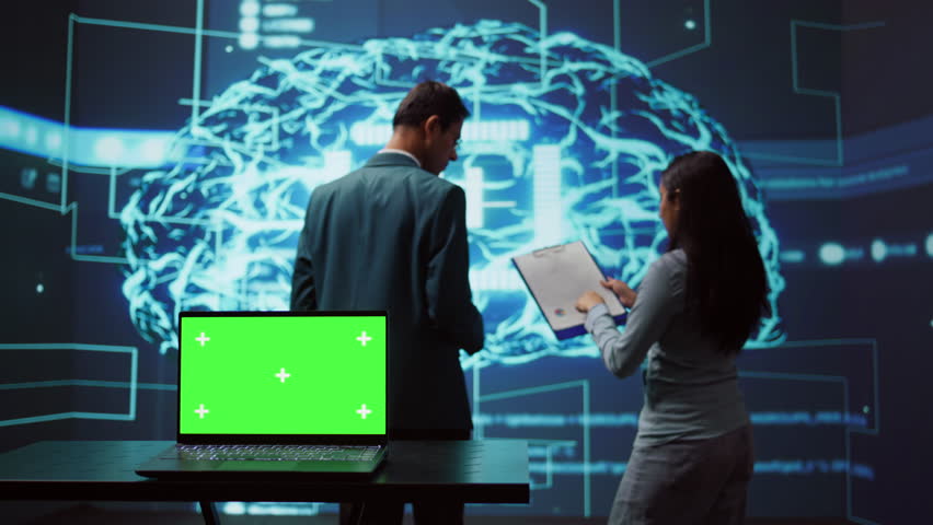 Teamworking AI technicians using green screen laptop for business data analysis. Team of IT experts works on mockup notebook to automatize tasks using artificial intelligence, camera B