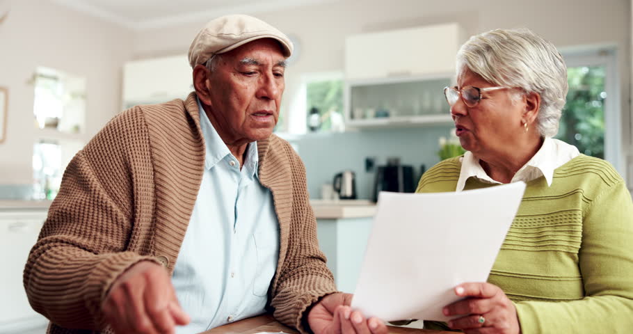 Frustrated, discussion and senior couple with document for debt, overdue payment or financial crisis in home. Paperwork, elderly man and stressed woman for disagreement, argument or retirement fund