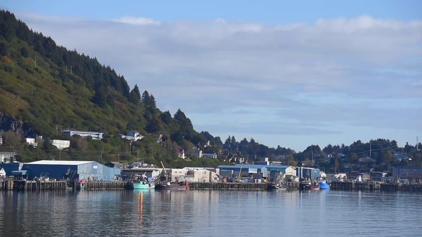 A shot of a lake with boats on it in Kodiak, Alaska.