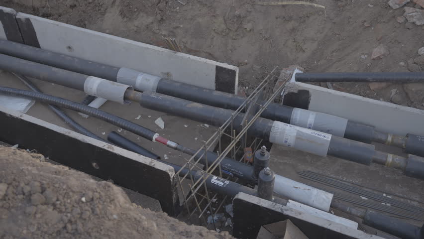 Durable pipelines in trench secured by cement blocks at wastewater plant. Modern water supply system for delivering safe water to residents