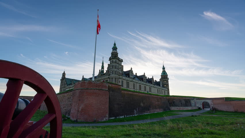Timelapse of the famous castle Kronborg in Helsingor north of Copenhagen in Denmark. A wheel of an old canon is in the foreground