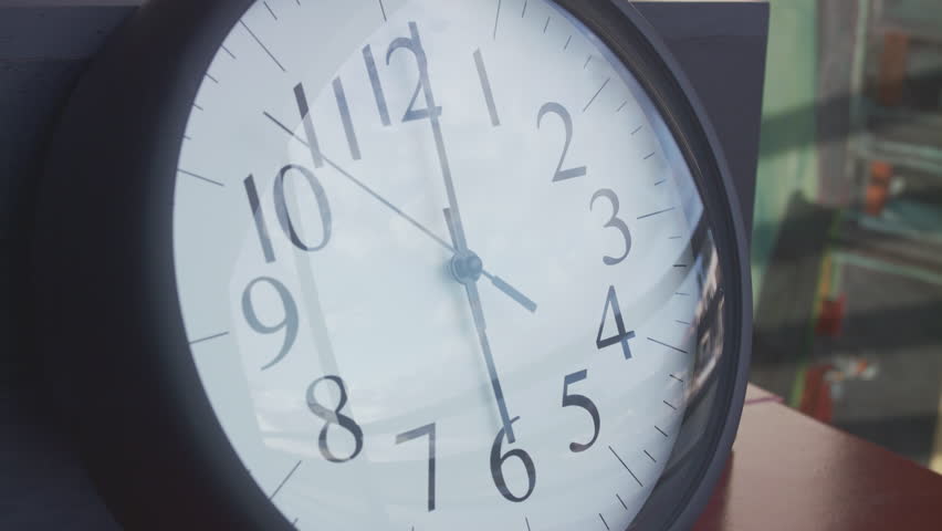 A closeup timelapse of a clock changing the time fast from 2:05 pm to 7:30 pm