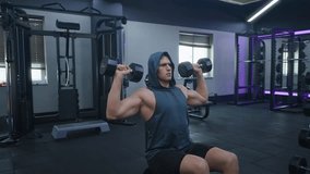 Muscular man exercising dumbbell shoulder press in the gym, lifestyle sport and bodybuilding concept - middle shot - Powered by Shutterstock - Get 15% off with code: PIKWIZARD15