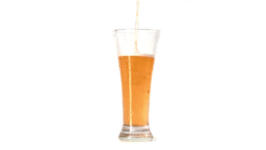 Pouring beer into glass, isolated shot in white background in studio, slow motion, craft light beer. Delicious alcoholic or non-alcoholic lager beer, traditional and modern brewing, enjoy cool drinks