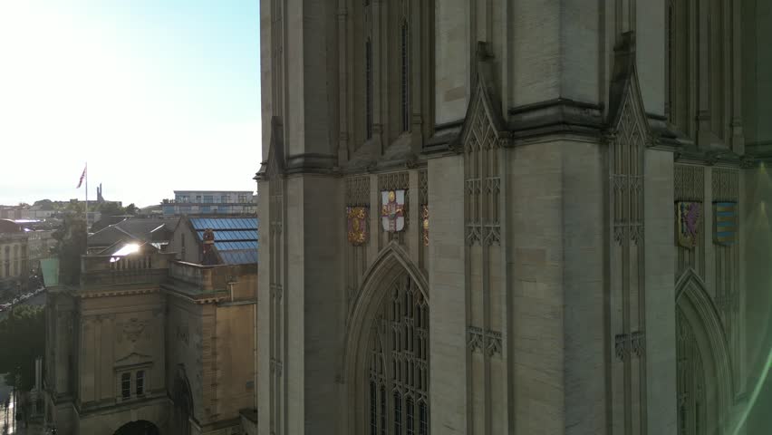 A drone shot of the facade of the historic Wills Memorial Building Tower at sunset in Bristol, England, UK