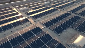Moving backwards above solar panel power plant on roof during sunset, aerial view. Rooftop PV modules for renewable energy generation drone shot - Powered by Shutterstock - Get 15% off with code: PIKWIZARD15
