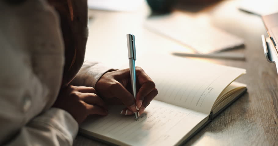 Hands, woman and writing in notebook or journal for ideas, planning and schedule as student. Female person, diary and agenda with wishlist or goals for future, vision and mission with affirmations