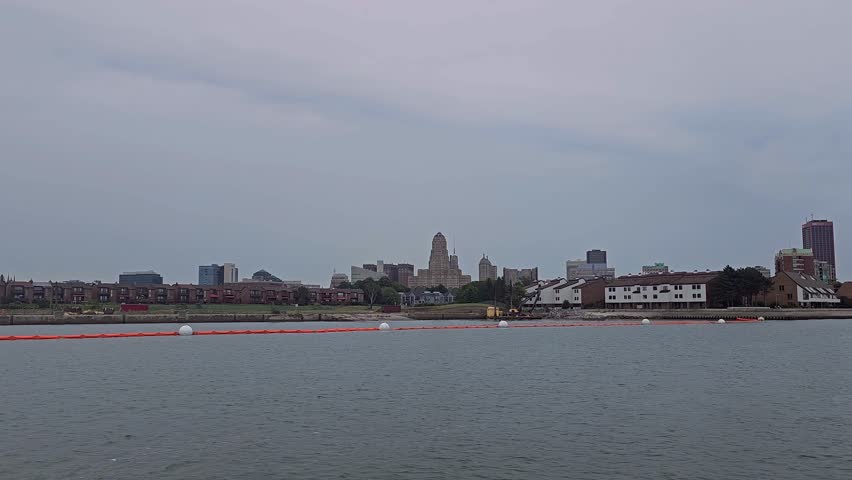 A view of Buffalo city Downtown while traveling on a boat in the Niagara River on a cloudy sunset time in New York, USA