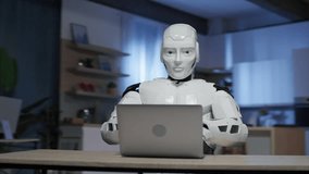Footage of white modern robot sitting at table and using laptop in living room. Android typing on keyboard. Robot humanoid working as copywriter and freelancer. AI thinking brain. Artificial - Powered by Shutterstock - Get 15% off with code: PIKWIZARD15