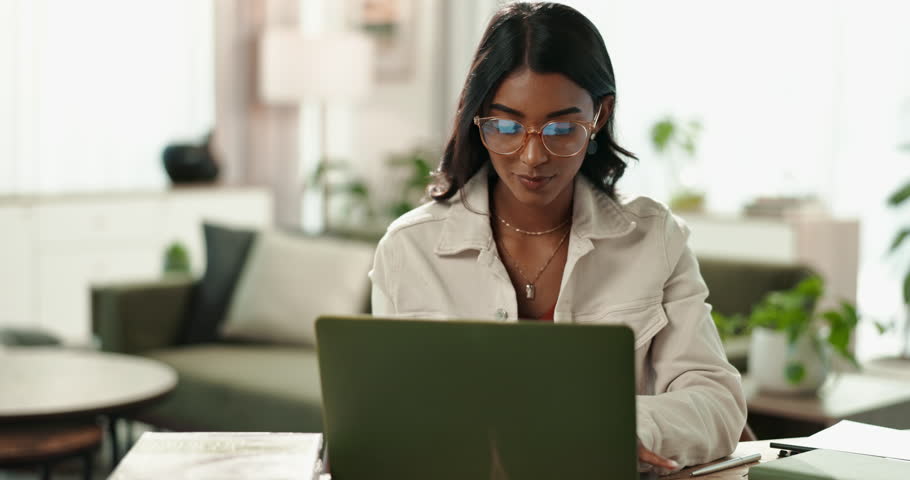 Laptop, Indian woman and student for online, typing and home with book for studying or project. Living room, research proposal and university learner, essay and female person with computer for email